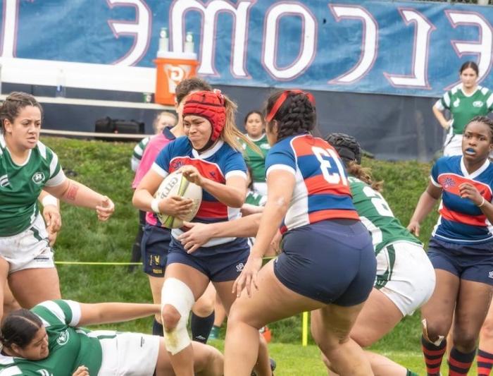 Saint Mary's women's rugby players carry the ball