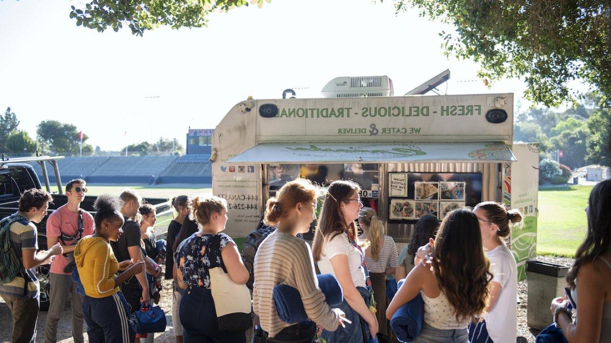 Students gathered outside of a food truck